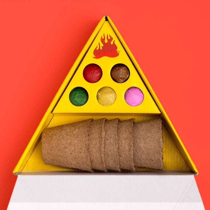 Hot pepper growing kit and pots in a triangular yellow box with a fire design on a red background