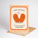 A birthday greeting card with a peach border and illustration of two smiling orange beans facing each other with small pink hearts. The text reads 'HAPPY BIRTHDAY TO MY FAVOURITE HUMAN BEAN'.