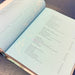 Open book with index pages on a wooden surface