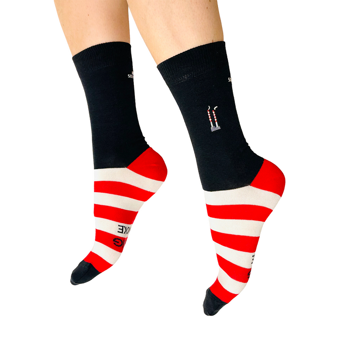 Black socks with red and white striped toes and heels on a white background