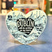 Heart-shaped decorative magnet with Dublin quote and cityscape design on a blue surface.