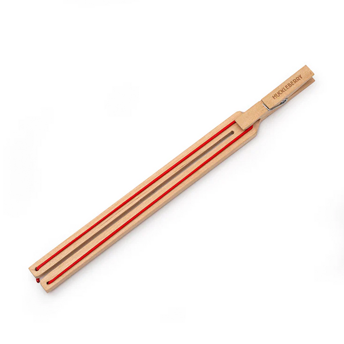 Wooden paper plane launcher with red string on a white background