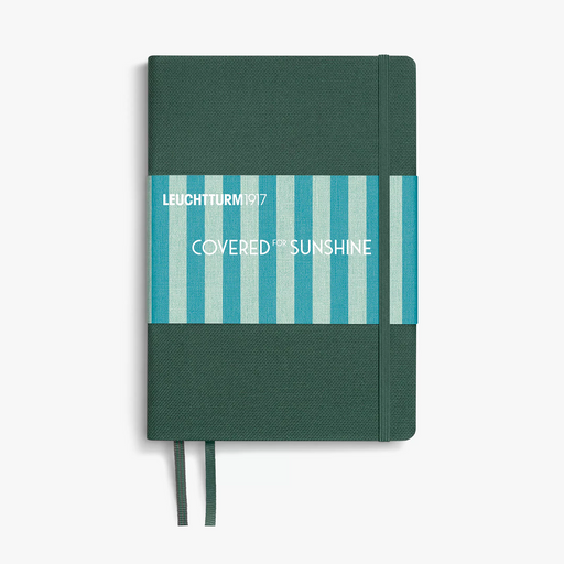 A Leuchtturm1917 notebook with a dark green textured cover, a blue and white striped paper band labeled 'COVERED IN SUNSHINE', and matching green ribbon bookmarks, shown on a light gray background.