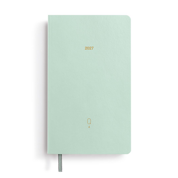 A mint green 2027 daily planner with a textured cover, gold foil year print, and a silver elastic pen loop, shown on a clean white background.