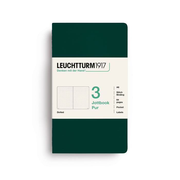 A Leuchtturm1917 notebook in dark green with a cream-colored paper label on the front, displayed on a clean white background.