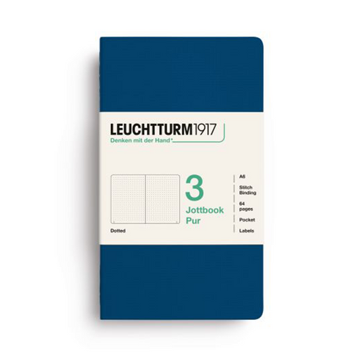 A Leuchtturm1917 Jottbook Pur pocket notebook with a solid navy blue cover and a cream-colored paper band around the middle, displayed on a clean white background.