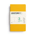 A Leuchtturm1917 notebook in a solid mustard yellow cover with a white paper band label, shown on a clean white background.