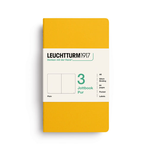 A Leuchtturm1917 notebook in a solid mustard yellow cover with a white paper band label, shown on a clean white background.