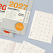 A set of 2027 Leuchtturm1917 planner stickers shown with a gray planner, open monthly calendar pages, and a separate January 2027 calendar page on a pale blue background.