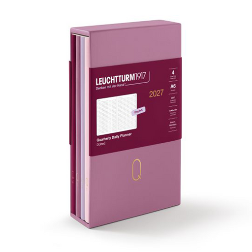 A Leuchtturm1917 2027 quarterly daily planner set in a dusty purple color, shown with its dark red paper band around the middle on a white background.