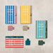 Collection of 'Covered in Sunshine' pen loops and packaging on a textured surface