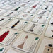 Collection of cards with illustrations of lighthouses and text on a beige surface