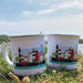 Two mugs with lighthouse design on grass with a scenic background