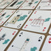 Playing cards with lighthouse illustrations on a brown background