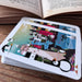 Playing cards with colorful illustrations on a wooden surface