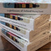 Stack of 'Lighthouses of Ireland Playing Cards' boxes on a wooden surface