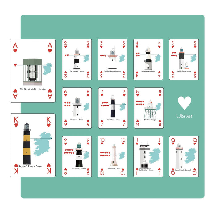 Set of playing cards with lighthouse designs on a teal background