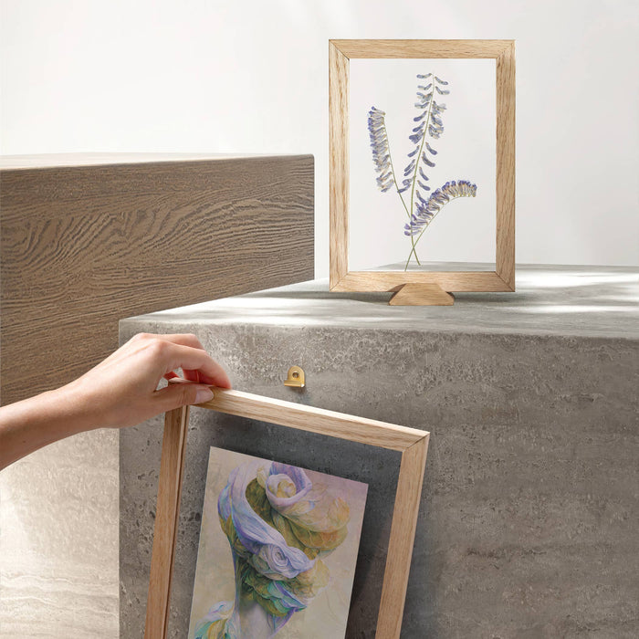 Framed artwork on a concrete surface with a neutral background