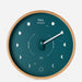 Wall clock with moon phases on a teal background