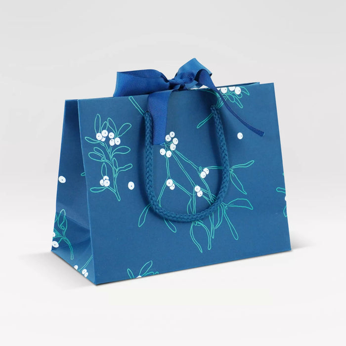 Blue gift bag with floral design on a white background