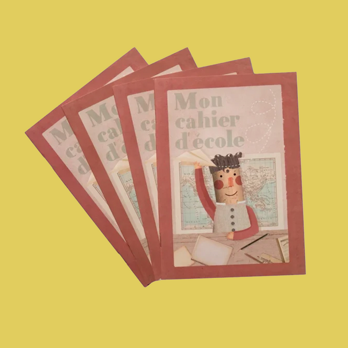 Four children's school notebooks with reddish-brown covers fanned out on a solid yellow background. The cover features a cute illustration of a pencil character writing in a notebook.