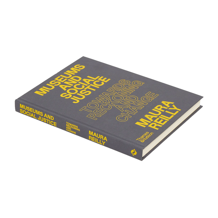 A hardcover book titled "Museums and Social Justice" by Maura Reilly, shown at an angle on a plain white background. The cover is dark gray with bold yellow text, and the spine is visible on the left side.