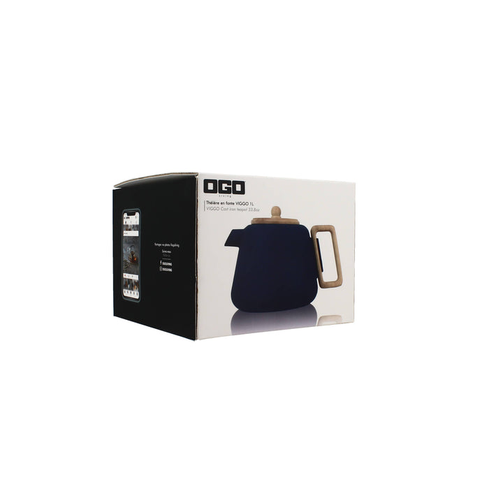 A boxed tea infuser set on a plain white background. The product box is white and black, featuring a printed image of a dark navy blue teapot with a light wood handle and lid.