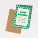 A green and white polka dot 'Happy Birthday' greeting card with a brown kraft envelope, shown on a light gray background.