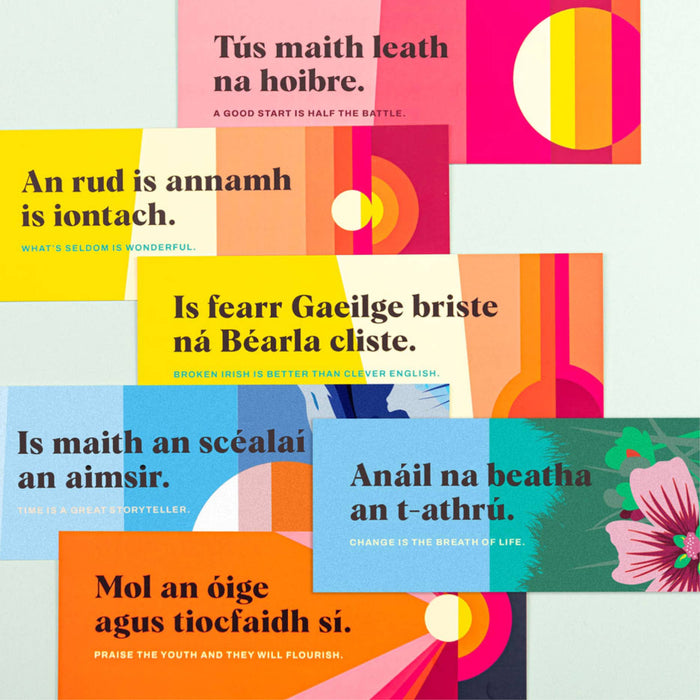 Collage of colorful bookmarks with proverbs in Irish and English on a light gray background.