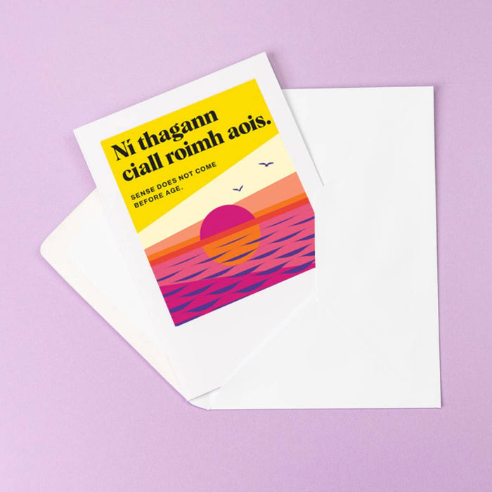 Greeting card with colorful sunset design and text on a purple background