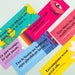 Colorful bookmarks with text and designs on a light gray background