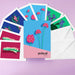 Set of colorful greeting cards with floral designs and box with 'peiteal' branding on a purple background.