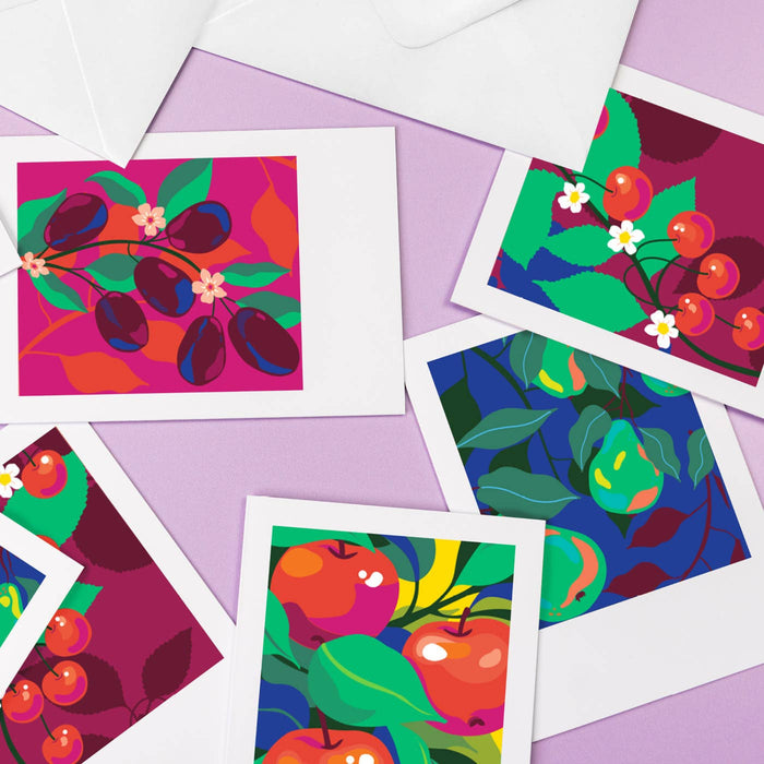 Colorful fruit and leaf patterned cards on a purple background