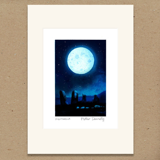 A matted art print featuring a night sky illustration with a large glowing full moon, stars, and dark stone monuments. The print has a wide cream mat border and the name Peter Donnelly printed below the artwork, displayed against a brown textured background.