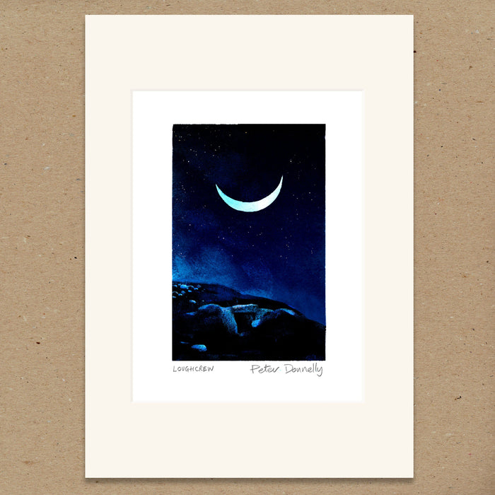 A matted art print featuring a crescent moon in a starry night sky over dark blue hills, displayed on a textured brown background.