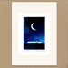 A matted art print featuring a watercolor illustration of a crescent moon in a starry night sky above a small house. The print has an off-white mat border and is displayed on a textured brown background.