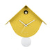 Yellow birdhouse-shaped clock with a white pendulum on a white background