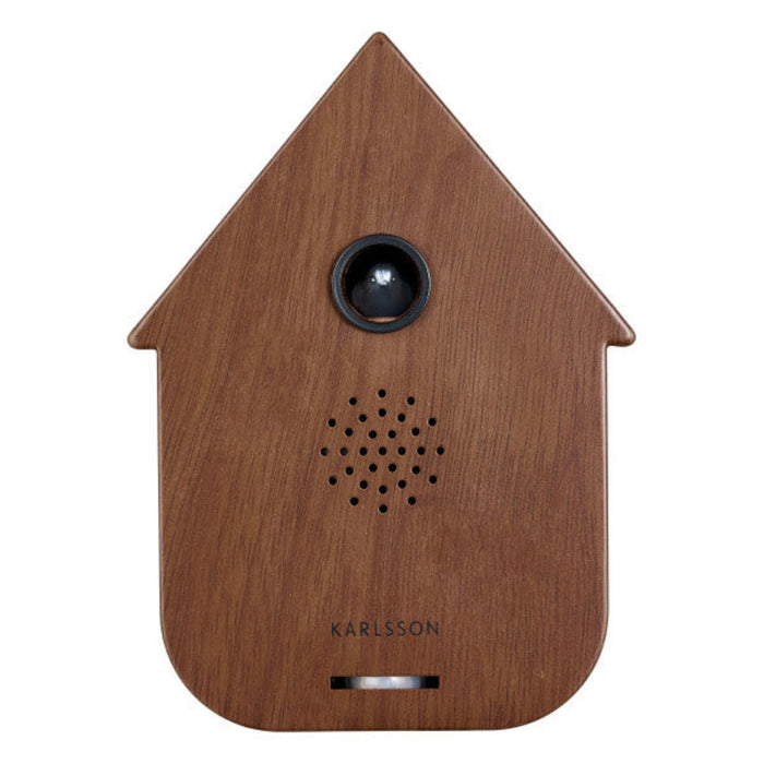 Wooden birdhouse-shaped speaker with a black speaker grille on a white background