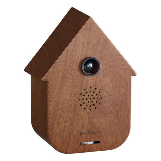 Wooden birdhouse-shaped speaker with a brown roof and white body on a white background