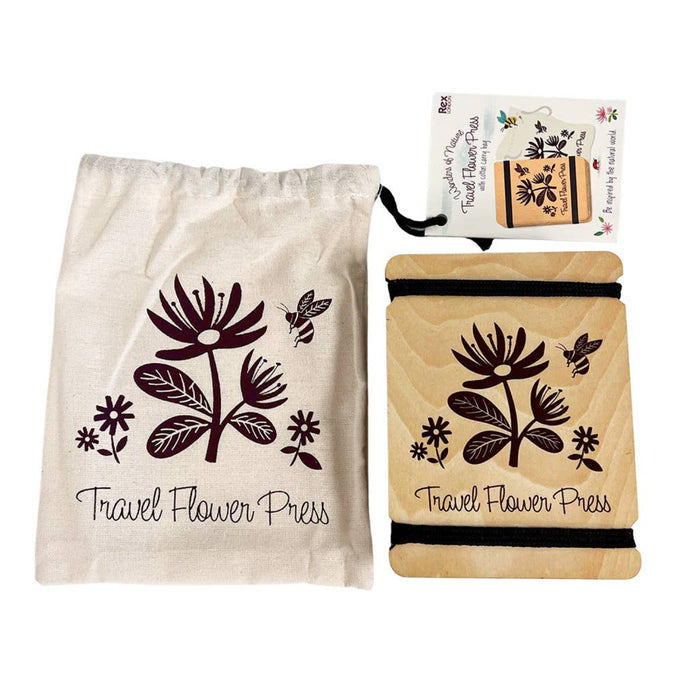 Travel flower press with floral design and matching drawstring bag on a white background