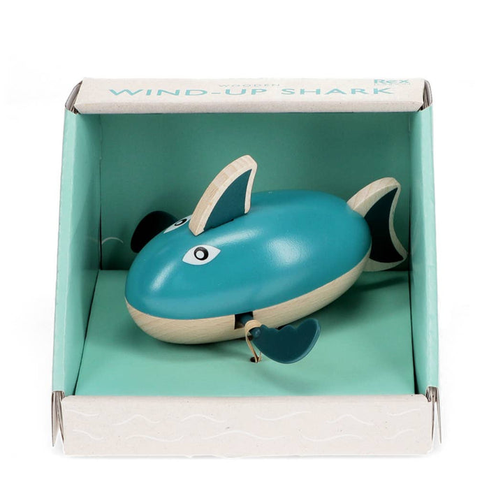 Wind-up shark toy in a box with a turquoise interior