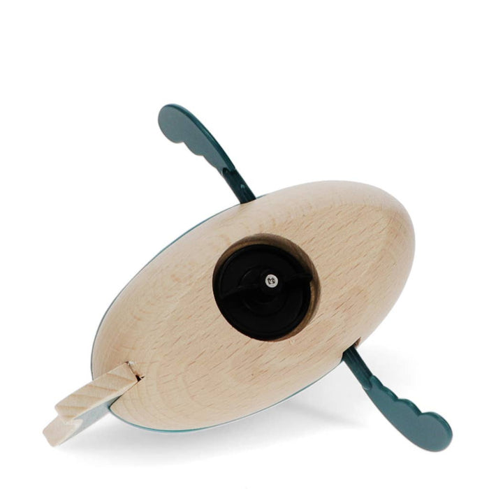 Underside of wooden toy shark against a white background