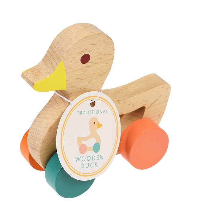 Wooden duck toy with colorful wheels and a tag on a white background