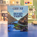 Book titled 'Great Irish Road Trips' on a blue surface with shelves in the background.