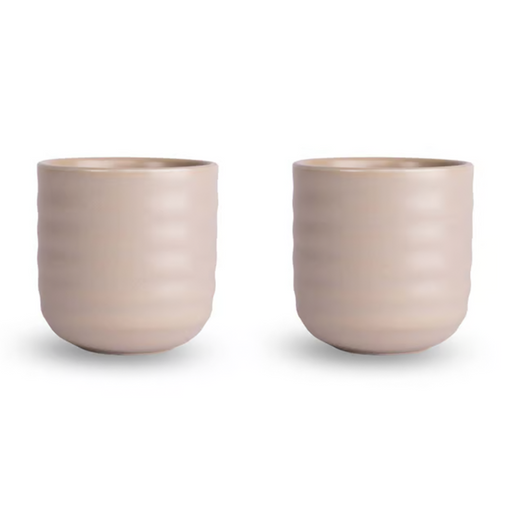 Two matching ribbed ceramic cups in a light warm beige color, shown side by side on a clean white background.