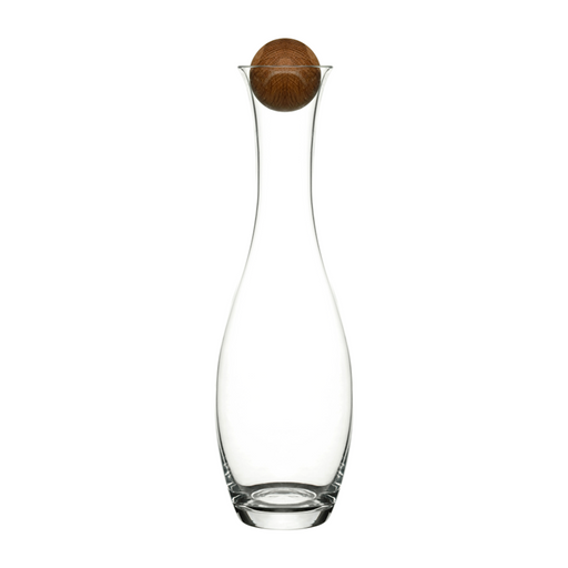 A clear glass carafe with a bulbous body and a dark brown wooden stopper, centered on a plain white background.