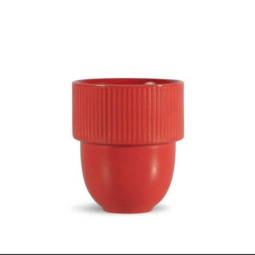 A small red plastic cup with a ribbed upper band and a smooth lower body, centered on a plain white background.