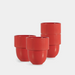 Three red ribbed ceramic cups with rounded bodies, arranged on a light gray studio background.