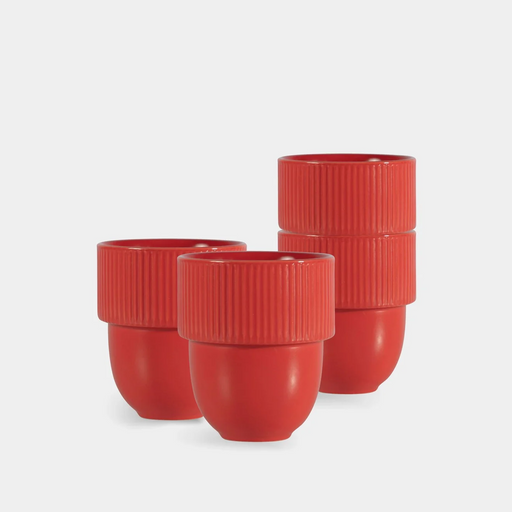 Three red ribbed ceramic cups with rounded bodies, arranged on a light gray studio background.