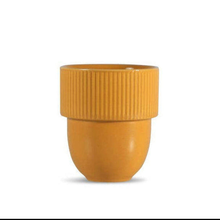 A small yellow-orange ceramic cup with a ribbed flared rim and a rounded base, centered on a plain white background.